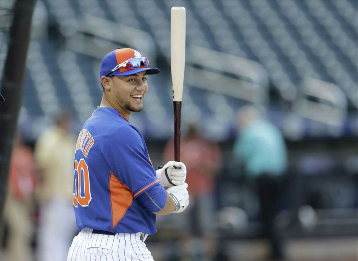 Mets rookie Michael Conforto warms up before his first major league game against the Los Angeles Dodgers on Friday night in New York.