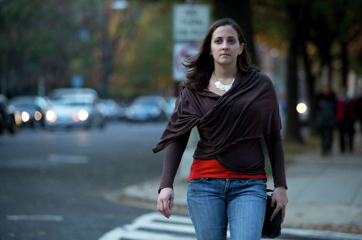 In this Nov. 11, 2014 photo, Laura Dunn, executive director of the sexual assault survivorsí organization SurvJustice, crosses the street in her neighborhood in Washington. Dunn, a victim of sexual assault, believes an affirmative consent standard could have helped her 2004 case during campus judicial proceedings, which failed to find wrongdoing, even after appeals.