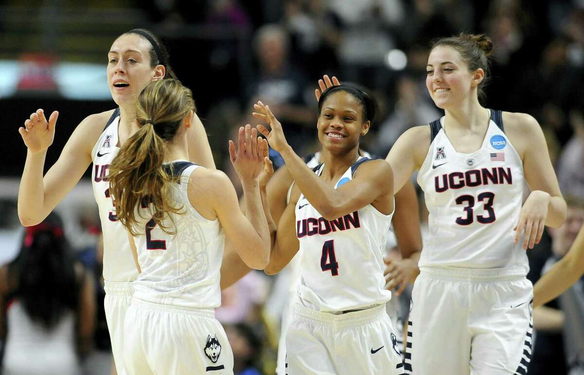 UConn’s Briana Pulido (2) is greeted by Breanna Stewart, left, Moriah Jefferson, center, and Katie Lou Samuelson at the end of Saturday’s NCAA tournament regional semifinal game in Bridgeport.
