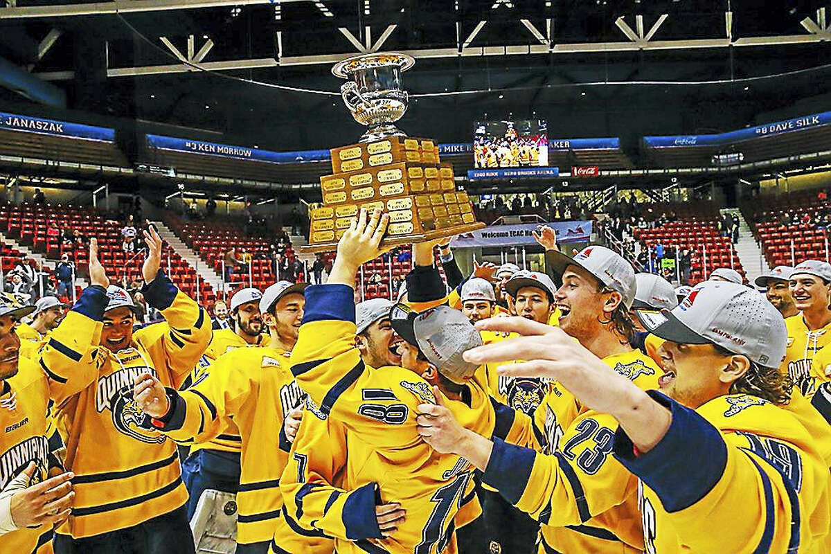 The Quinnipiac men’s hockey team holds up the ECAC Hockey tournament championship trophy earlier this month. Register columnist Chip Malafronte says it’s probably in the Bobcats best interest to remain in ECAC Hockey, rather than accept any invitation to fill the newly created vacancy in Hockey East.
