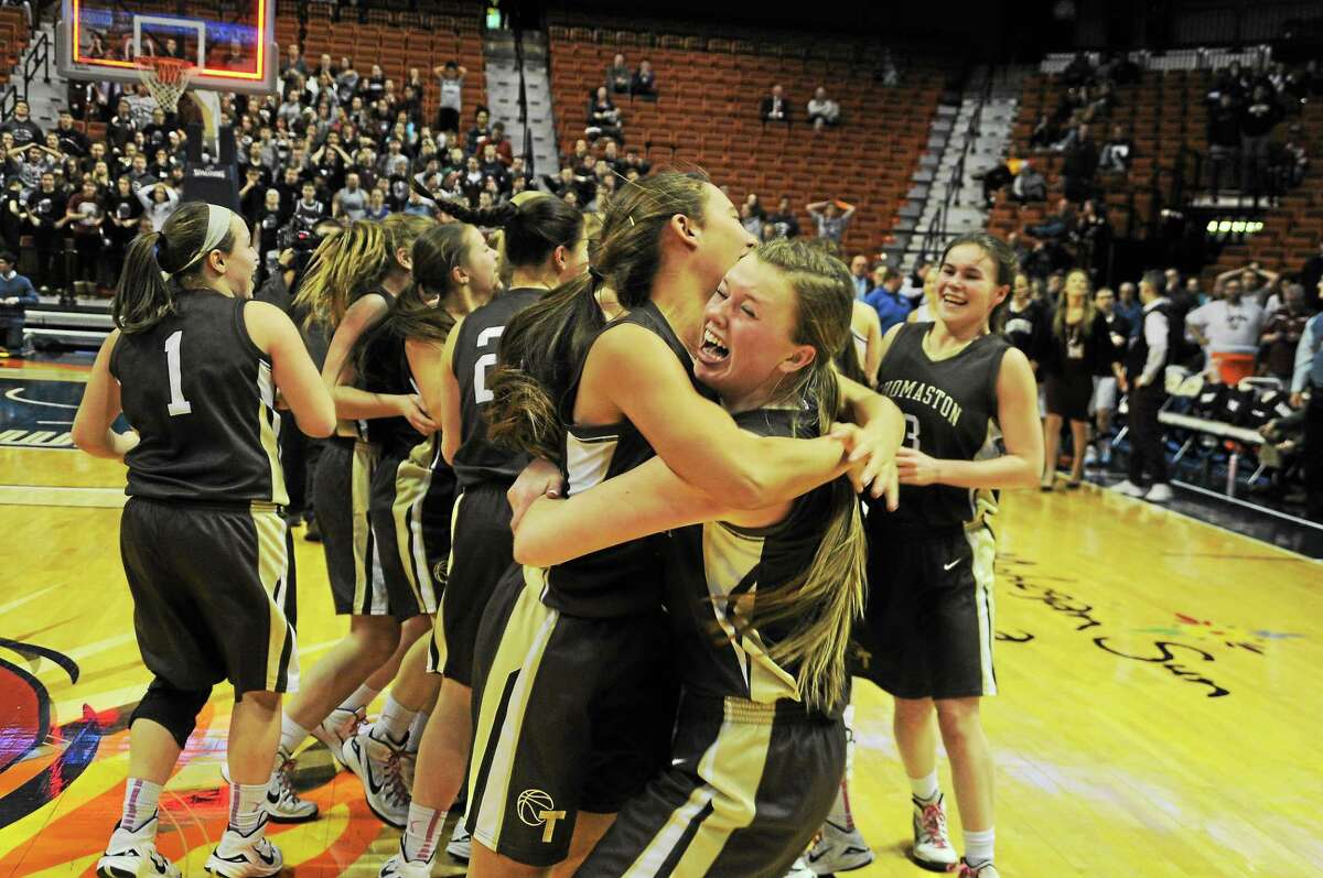 Sean Meenaghan / GameTimeCT.com The Thomaston girls basketball team celebrates it Class S state championship victory over Canton Saturday at Mohegan Sun.