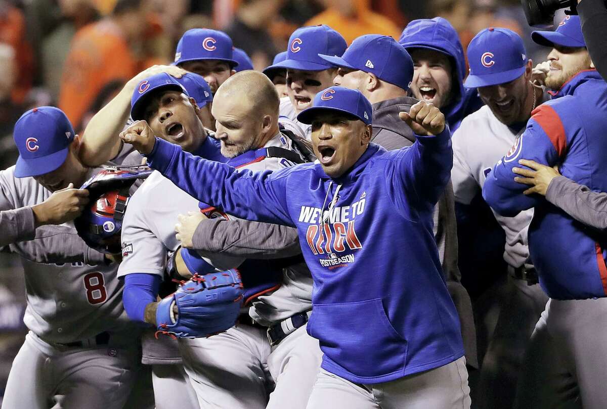 Chicago Cubs pitcher Aroldis Chapman, second from left, catcher David Ross, third from left, and teammates celebrate after Game 4 of baseball’s National League Division Series against the San Francisco Giants in San Francisco, Tuesday. The Cubs rallied in the ninth inning for a 6-5 win.