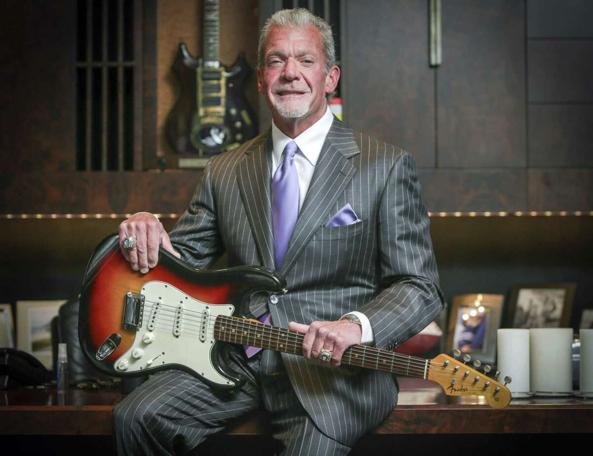 In this June 10, 2014, file photo, Indianapolis Colts owner and CEO Jim Irsay holds in Indianapolis the Fender Stratocaster guitar that Bob Dylan played at the Newport Folk Festival in 1965. Irsay purchased it at auction for just under $1 million.