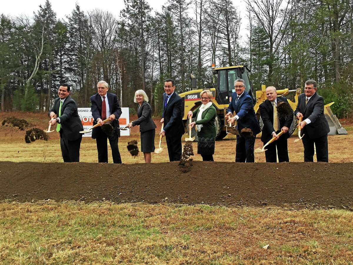 DECD Commissioner Catherine Smith, Gov. Dannel P. Malloy, Mayor Elinor Carbone and FuelCell President and CEO Chip Bottone, among others toss a shoveful of dirt during the groundbreaking ceremony held Thursday to celebrate the planned expansion of the Torrington FuelCell Energy manufacturing facility.