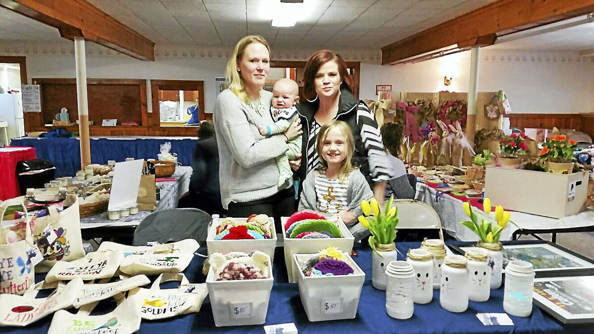 T&C Designs By 2 Crafty Mamas’ Amie-Jaye Campbell and Heather Tomala of New Hartford, with Campbell’s children, Emmett , 5 months, and Cambria, 7, showed their homemade crocheting, vases, and graphic designs among 14 participating vendors at the Winchester Grange’s fifth annual Cabin Fever Craft & Bake Sale in Winchester Saturday.