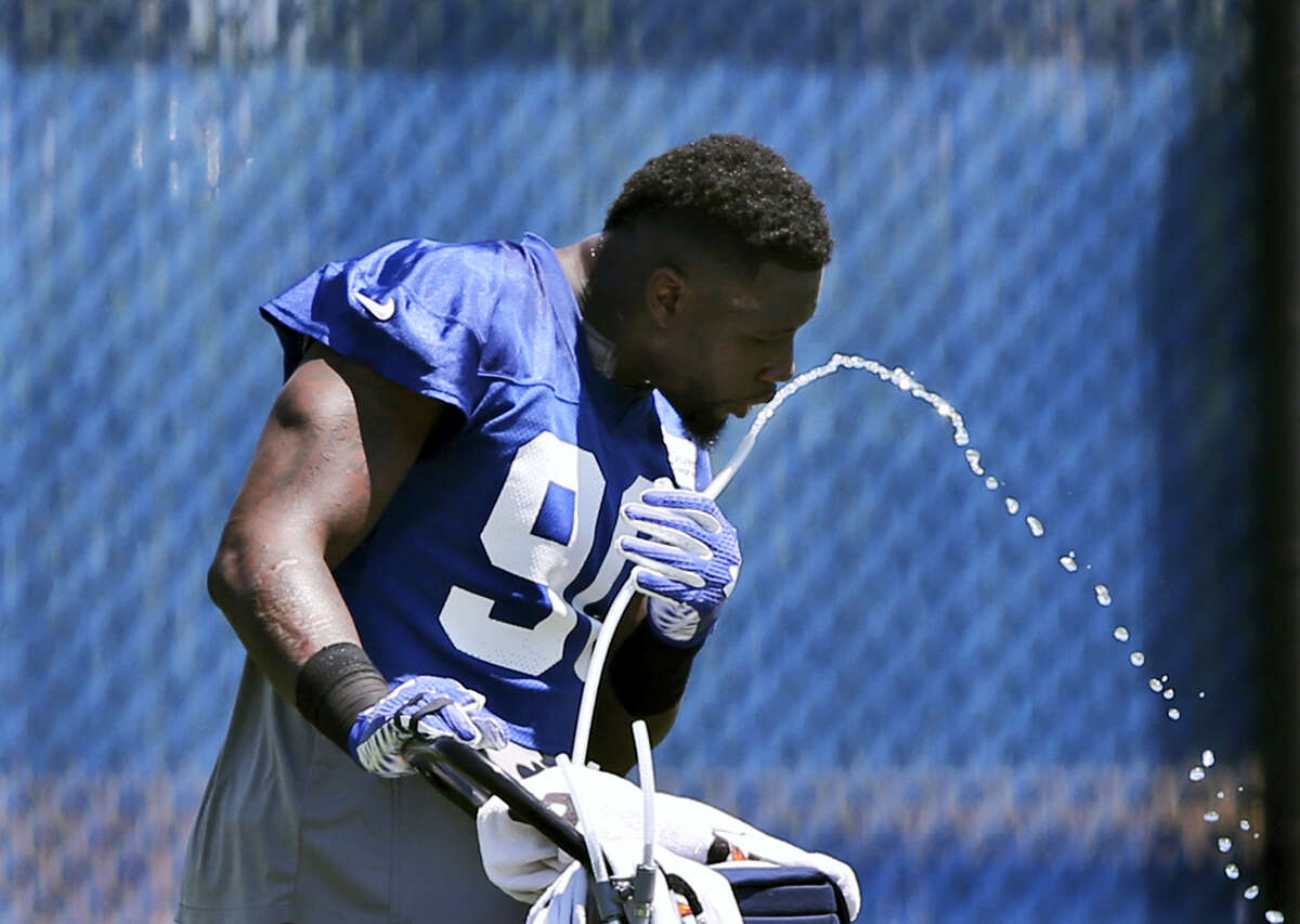 Defensive end Jason Pierre-Paul drinks water during practice at the Giants training facility on Monday.