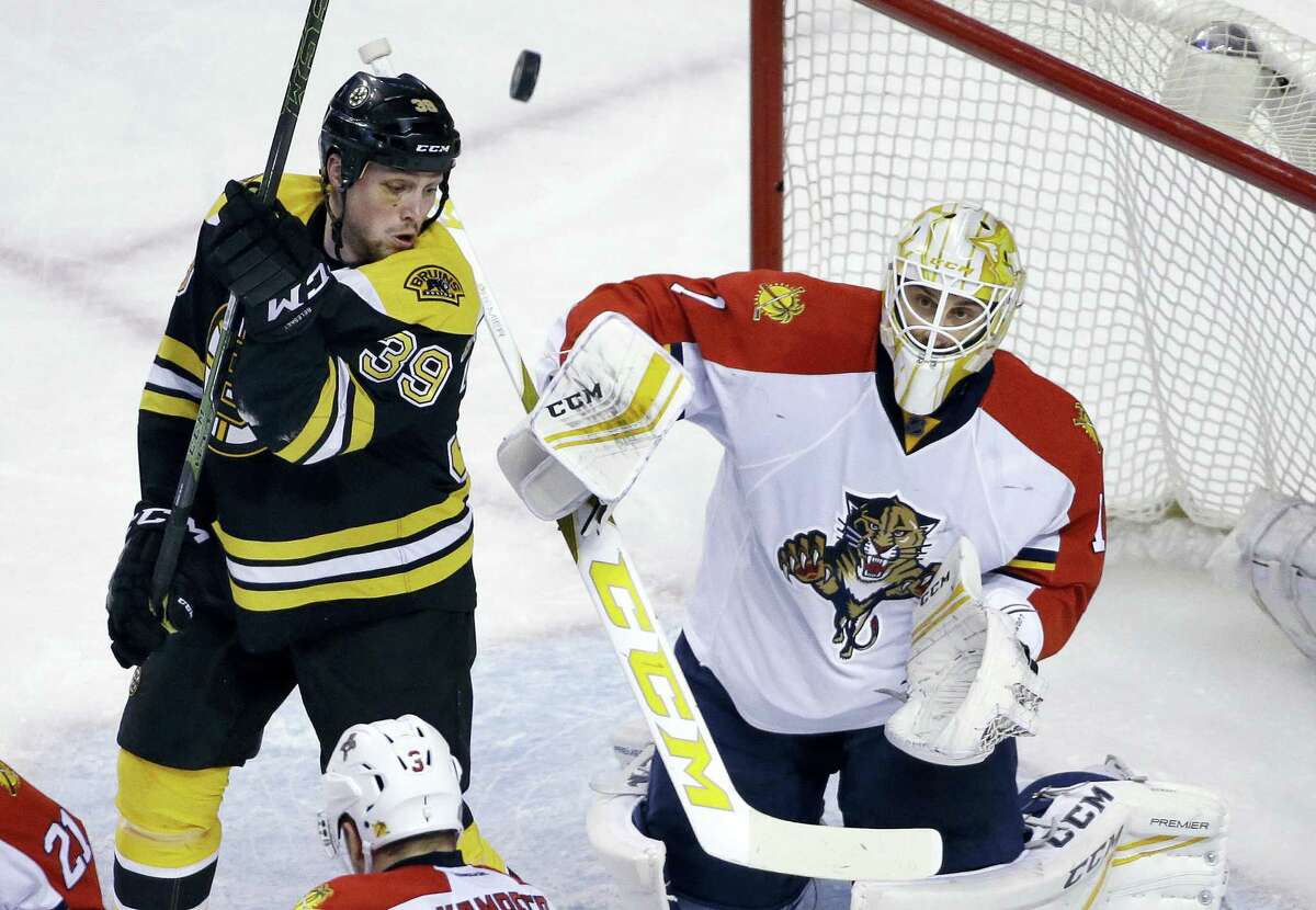 Boston Bruins left wing Matt Beleskey (39) watches as Florida Panthers goalie Roberto Luongo (1) deflects the puck in the first period of an NHL hockey game, Thursday, March 24, 2016, in Boston. (AP Photo/Elise Amendola)