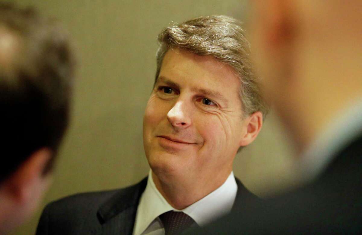 New York Yankees owner Hal Steinbrenner speaks with reporters in the lobby of the hotel hosting the baseball owners meeting on Wednesday in Dallas.