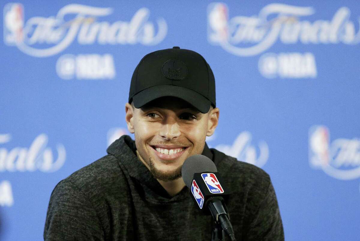Stephen Curry smiles at a news conference after Game 2 of the NBA Finals on Sunday.