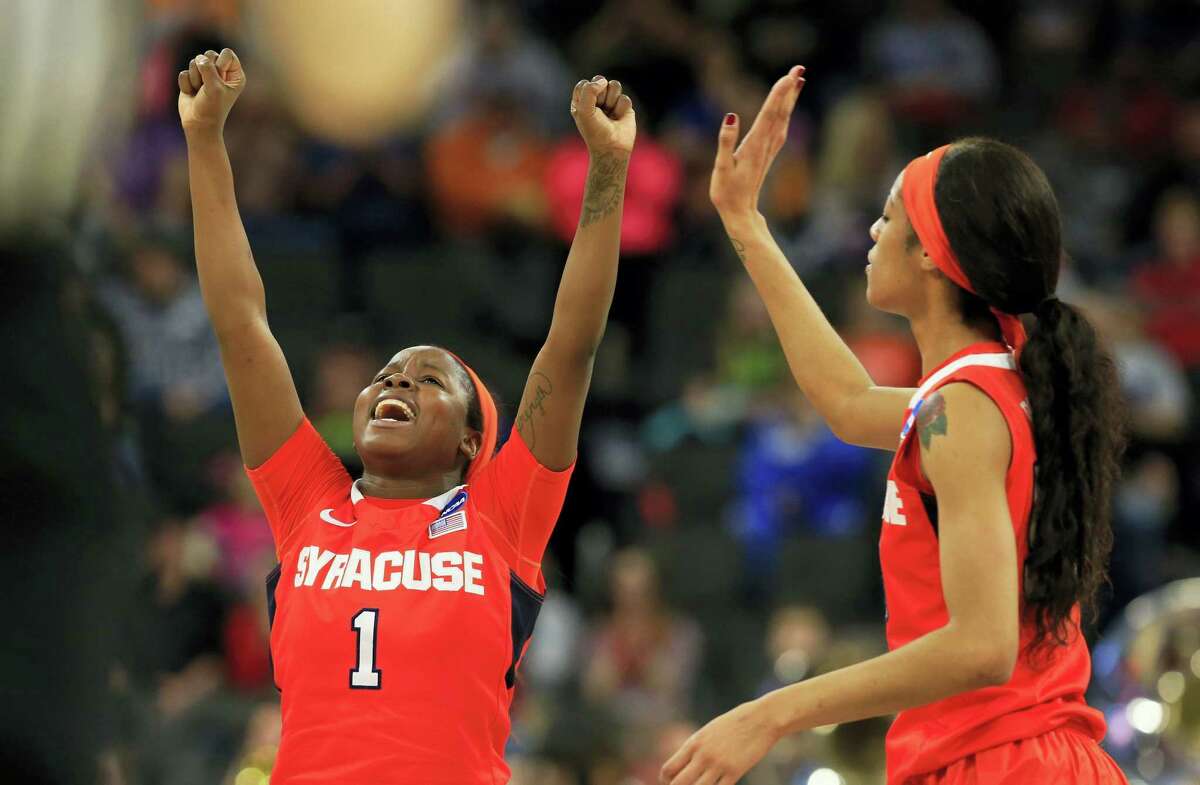 Syracuse’s Alexis Peterson (1) and Briana Da, right, celebrate following Friday’s win over top-seeded South Carolina.