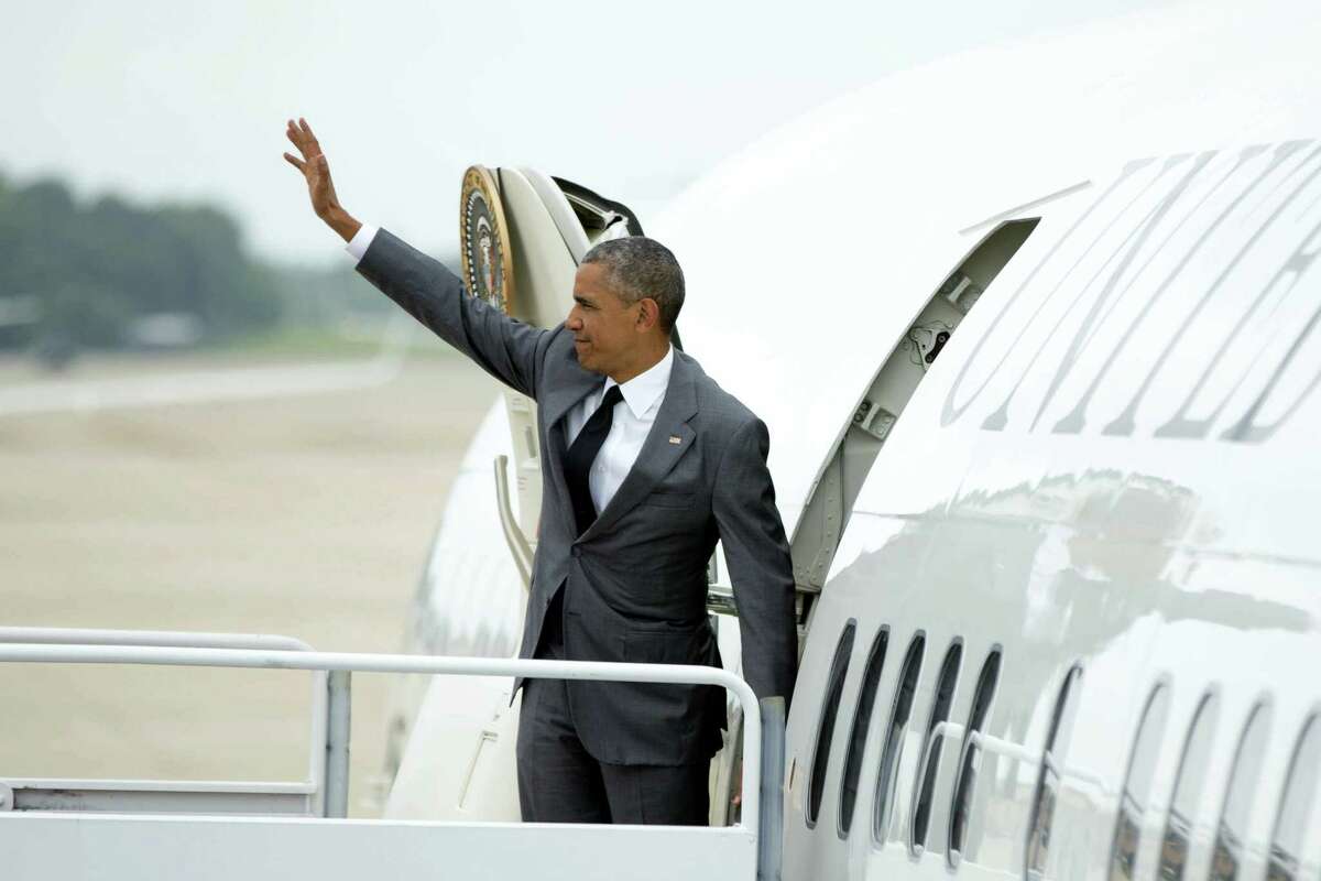 President Barack Obama waved as he boarded Air Force One at Andrews Air Force Base, Maryland, on Friday to travel to Miami for a Democratic Senatorial Campaign Committee roundtable and a DNC event.