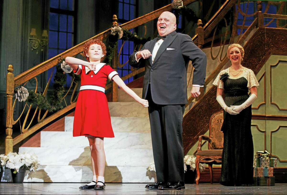 From left, Heidi Gray as Annie, Gilgamesh Taggett as Oliver Warbucks and Chloe Tiso as Grace Farrell sing “I Don’t Need Anything But You.”