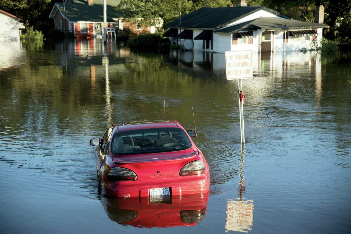 A car is submerged in floodwaters caused by rain from Hurricane Matthew in Lumberton, N.C., Monday, Oct. 10, 2016.