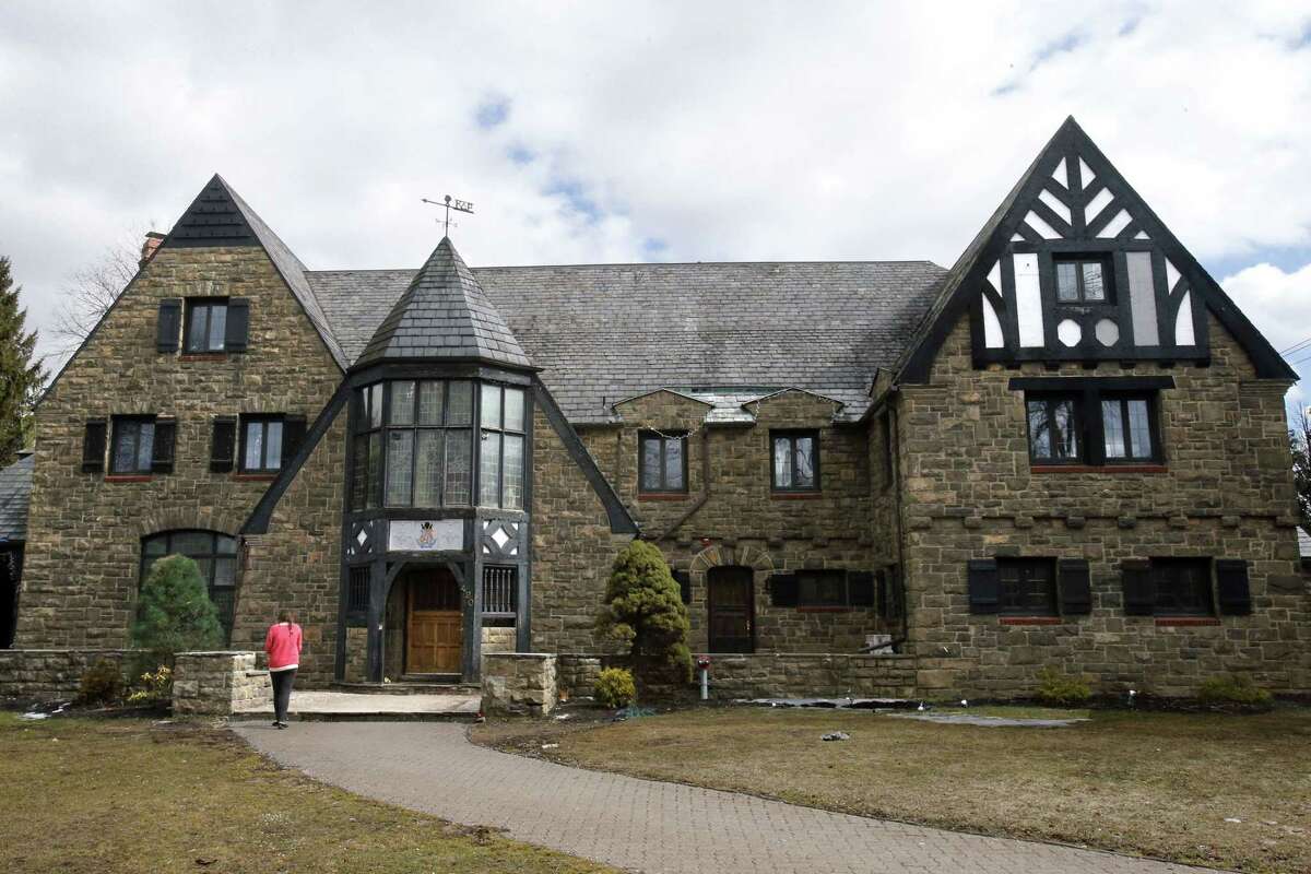 A reporter walks up to the front door of the Kappa Delta Rho fraternity house Tuesday, March 17, 2015, at Penn State University in State College, Pa. The fraternity has been suspended as police investigate allegations that members used a private, invitation-only Facebook page to post photos of nude and partly nude women in sexual and other embarrassing positions, some apparently asleep or passed out. (AP Photo/Gene J. Puskar)