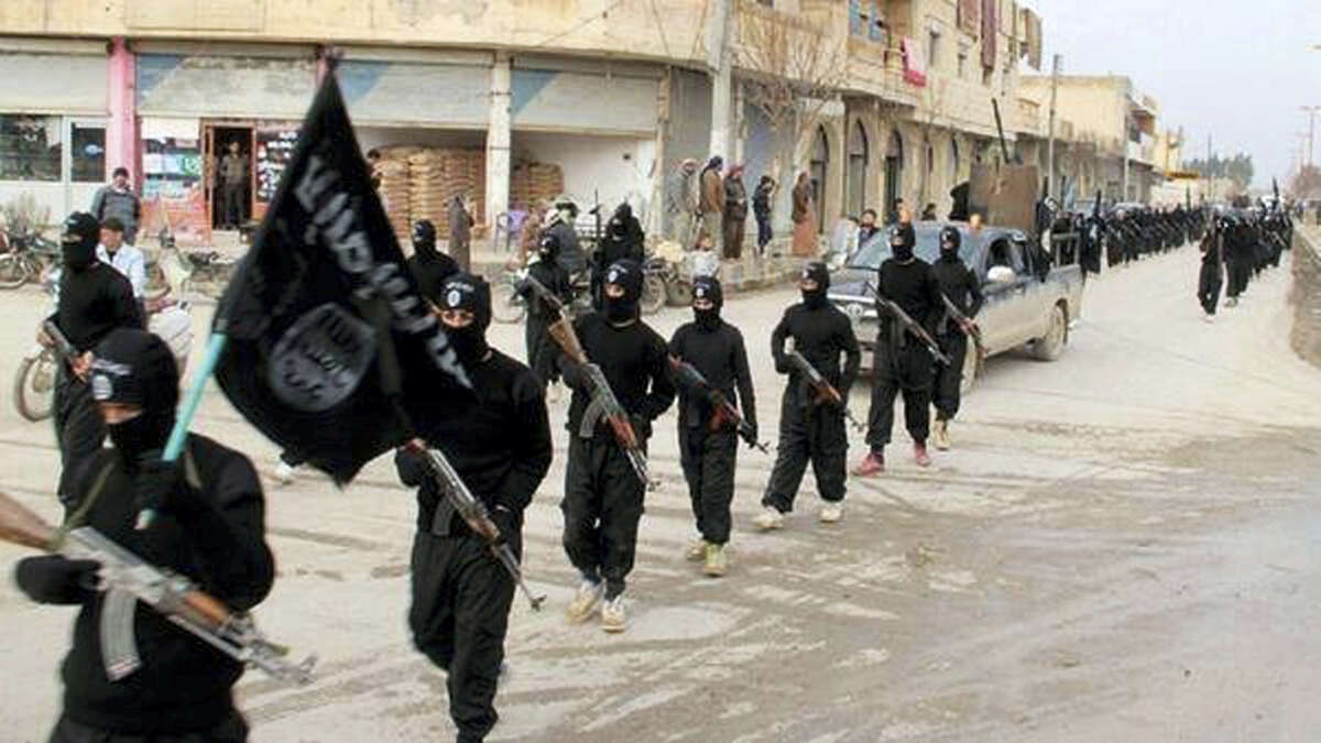 This undated file image posted on a militant website on Jan. 14, 2014, which has been verified and is consistent with other AP reporting, shows fighters from the al-Qaida linked Islamic State of Iraq and the Levant (ISIL), now called the Islamic State group, marching in Raqqa, Syria. The Islamic State group has killed dozens of its own members over the past weeks in a hunt for spies and informants after U.S.-led coalition airstrikes hit a number of high-level jihadis.