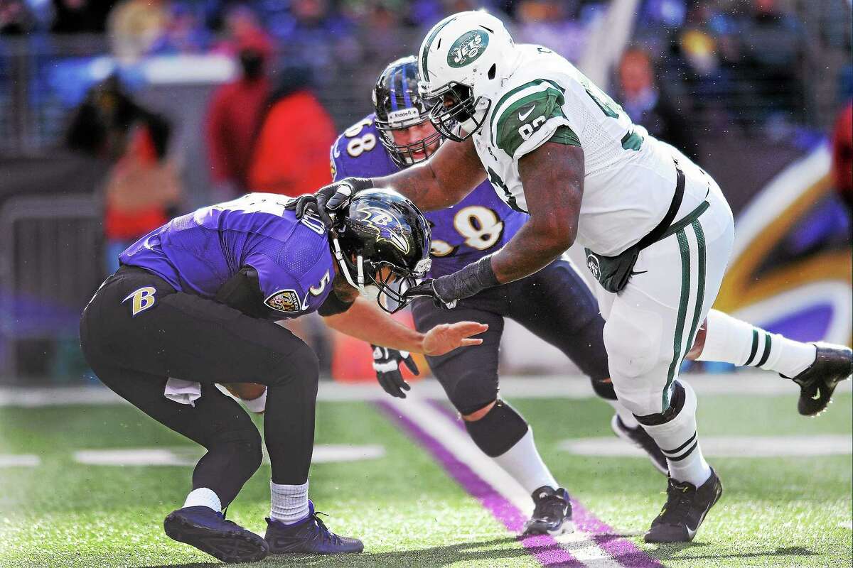 Baltimore Ravens quarterback Joe Flacco is sacked by New York Jets defensive end Kenrick Ellis during a 2013 game.