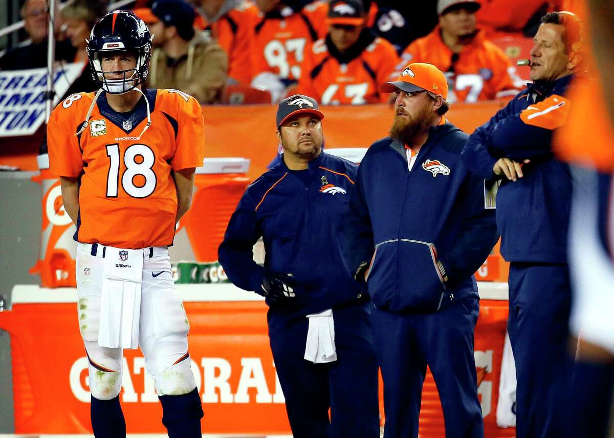Broncos quarterback Peyton Manning watches from the sidelines during the second half against the Chiefs on Sunday.