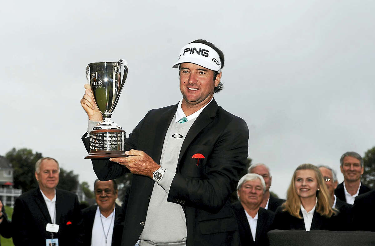 Bubba Watson holds the championship trophy after winning the 2015 Travelers Championship.