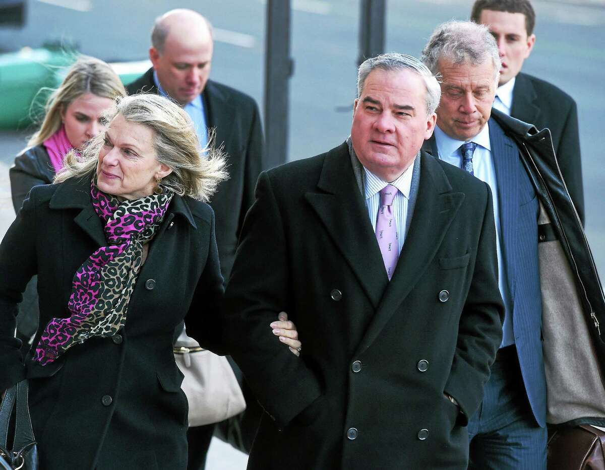 (Arnold Gold-New Haven Register) Former Connecticut Governor John Rowland (right) walks into Federal Court in New Haven for sentencing with his wife, Patty, on 3/18/2015.
