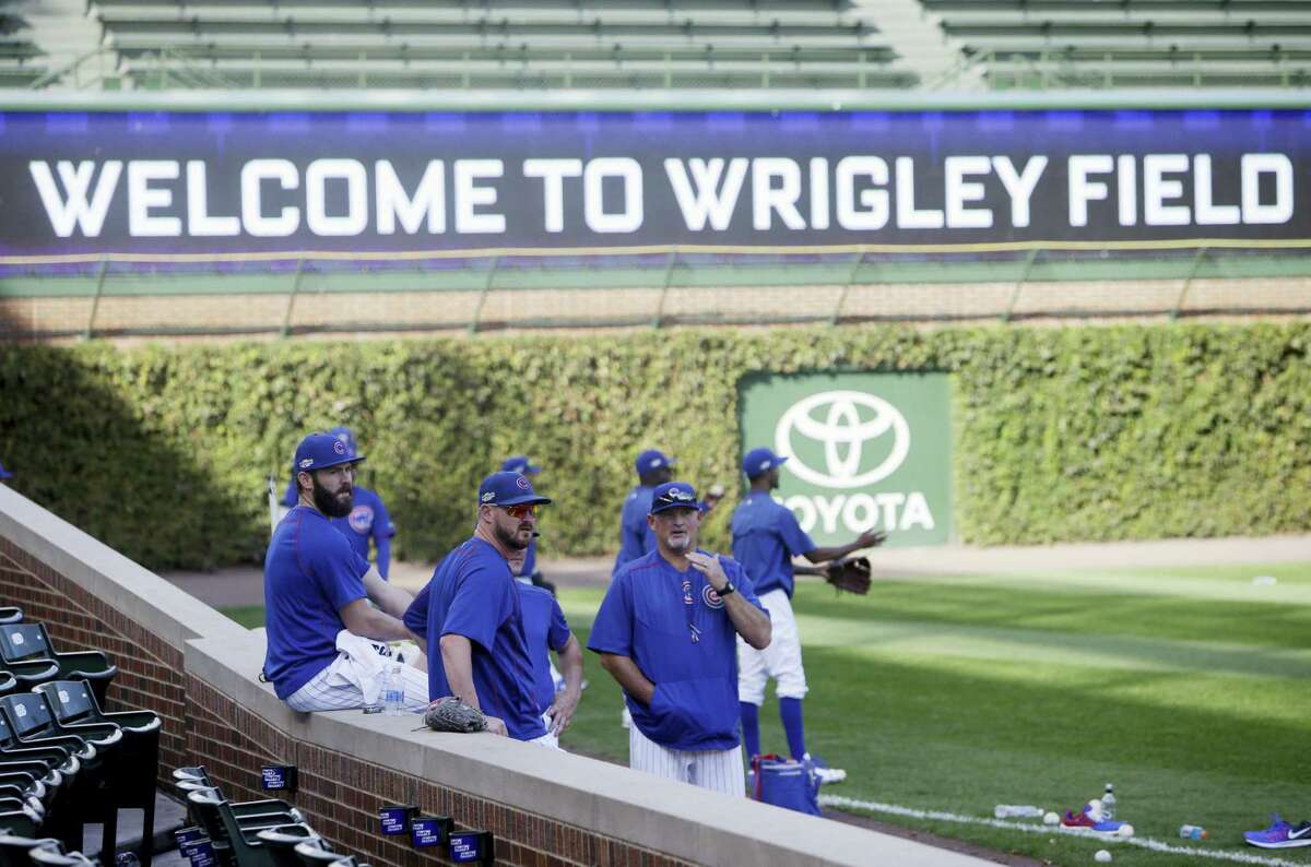 Chicago Cubs Chicago Cubs pitcher Jake Arrieta, left, relaxes as players warm up during baseball practice at Wrigley Field on Oct. 5, 2016 in Chicago. The Cubs host the winner of Wednesday’s National League wild-card game between the New York Mets and San Francisco Giants on Friday, in Game 1 of the National League Division Series.