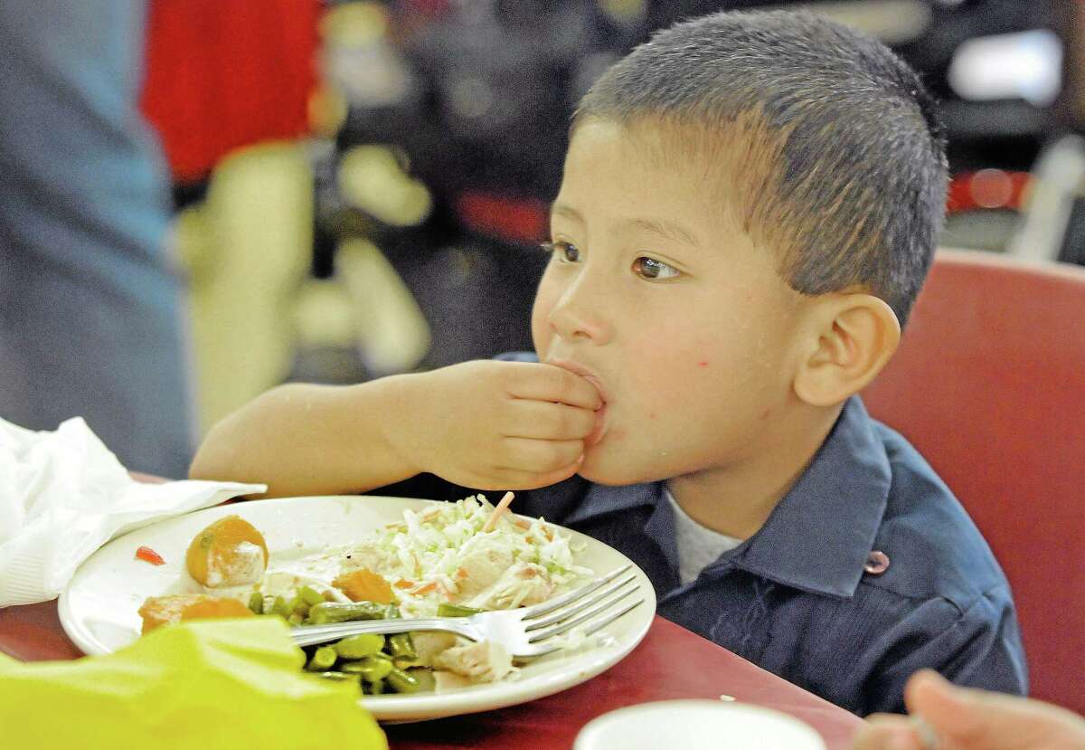 Javier Garcia, 3, of West Chester, Pa., eats during the 29th annual Thanksgiving Dinner celebration at the West Chester Senior Center.