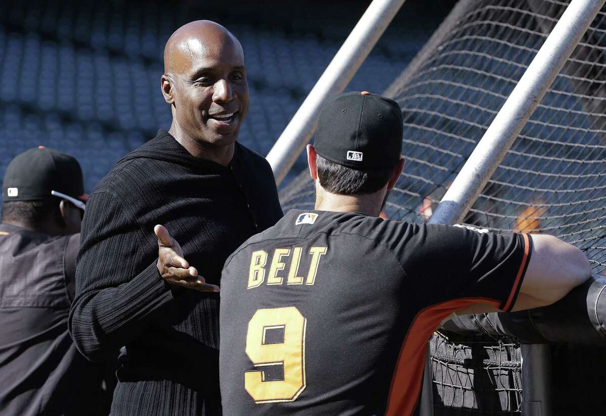 Barry Bonds, left, talks with first baseman Brandon Belt during batting practice before a game between the Giants and the Philadelphia Phillies on July 10 in San Francisco.