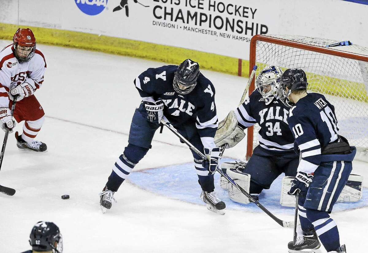 Boston University’s Danny O’Regan, far left, gets ready to shoot the game-winning goal past Yale goaltender Alex Lyon (34), Rob O’Gara (4) and Mitch Witek (10) during overtime of an NCAA regional semifinal game in March in Manchester, N.H.