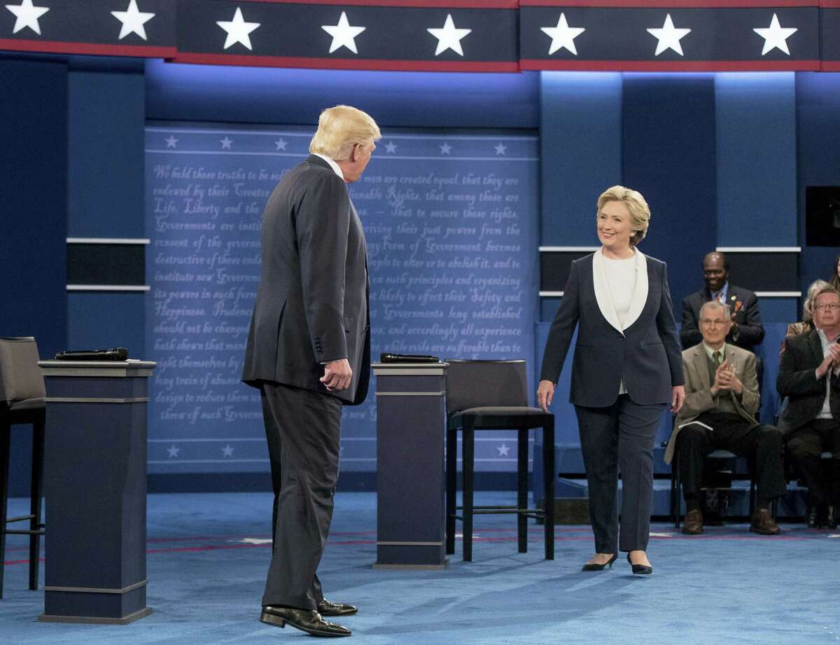 Democratic presidential candidate Hillary Clinton and Republican presidential candidate Donald Trump greet each other at the second presidential debate at Washington University on Oct. 9, 2016 in St. Louis.