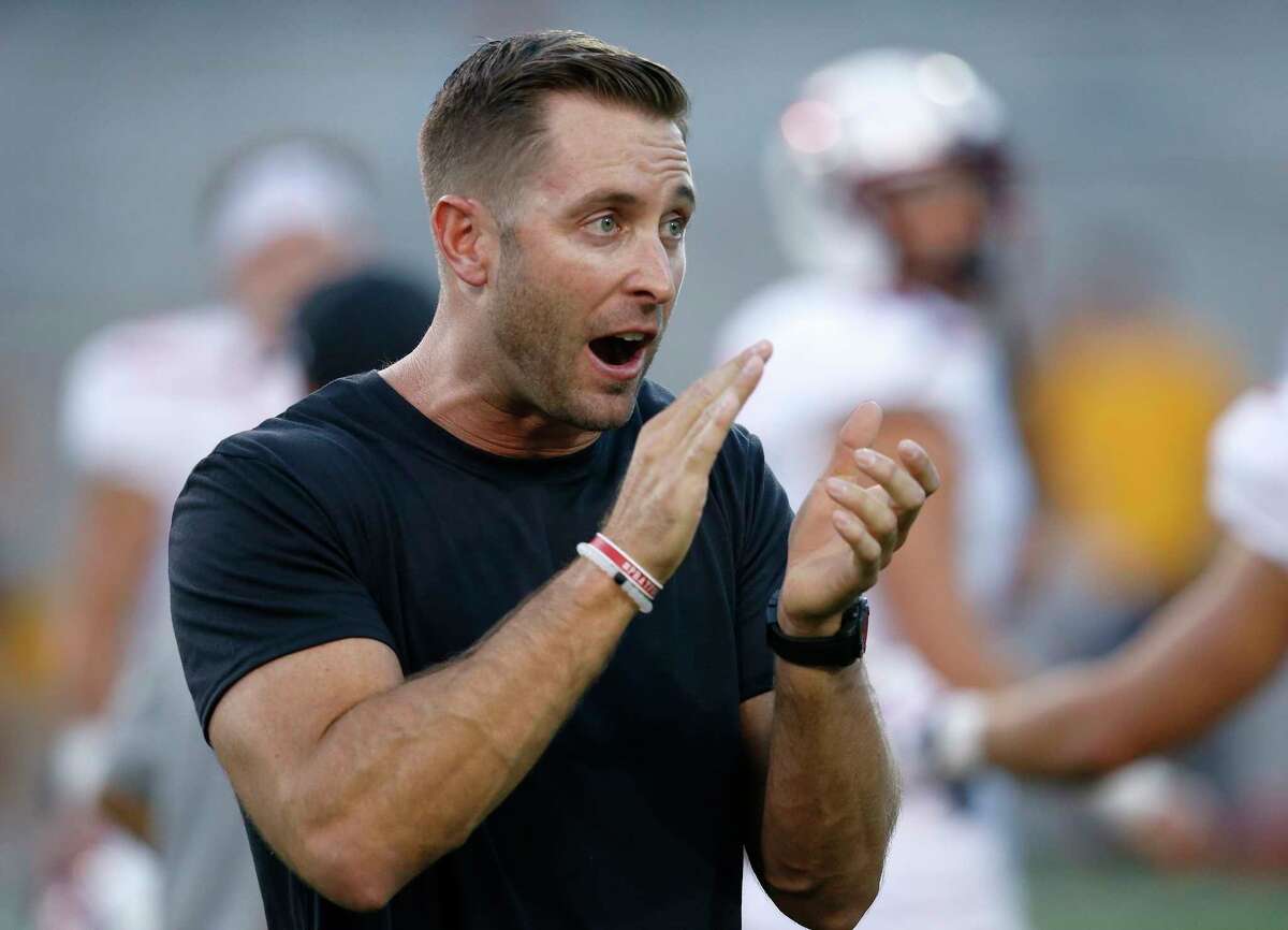 File- This Sept. 10, 2016, file photo shows Texas Tech head coach Kliff Kingsbury applauding as they warm up prior to an NCAA college football in Tempe, Ariz. LeachÂ?’s former Tech quarterbacks are gaining prominence as coaches at Big 12 programs. Lincoln Riley recently was promoted from offensive coordinator to head coach at Oklahoma. Kingsbury has been the head coach at Texas Tech since 2013, and his offenses have been nearly unstoppable. Sonny Cumbie is entering his fourth season as TCUÂ?’s co-offensive coordinator, and his units with quarterback Trevone Boykin were among the best in college football. (AP Photo/Ross D. Franklin, File)