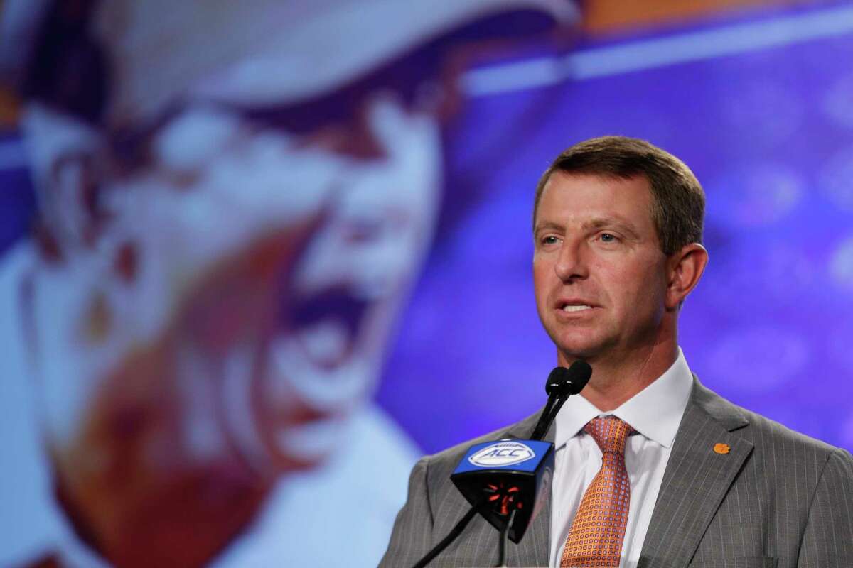 File-This July 13, 2017, file photo shows Clemson head coach Dabo Swinney speaking to the media during the Atlantic Coast Conference NCAA college football media day in Charlotte, N.C. Swinney is getting a hefty raise after winning the national championship. The university announced Friday, Aug. 25, 2017, its Board of Trustees approved a new 8-year, $54 million contract for Swinney. The deal pays Swinney $6 million this season, has $3.2 million in signing bonuses in three installments and includes a $6 million buyout until the end of 2018. (AP Photo/Chuck Burton, File)