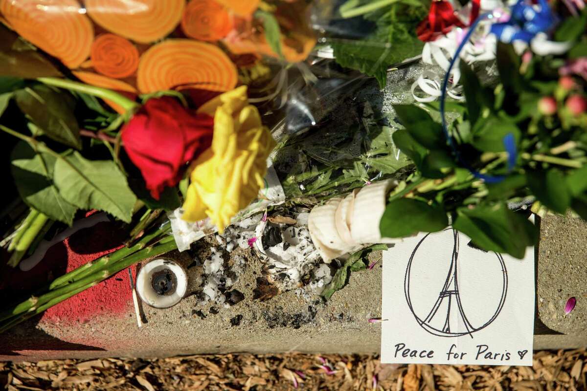 Mourners leave flowers and cards outside the gates of the French Embassy in Washington on Nov. 15, 2015.