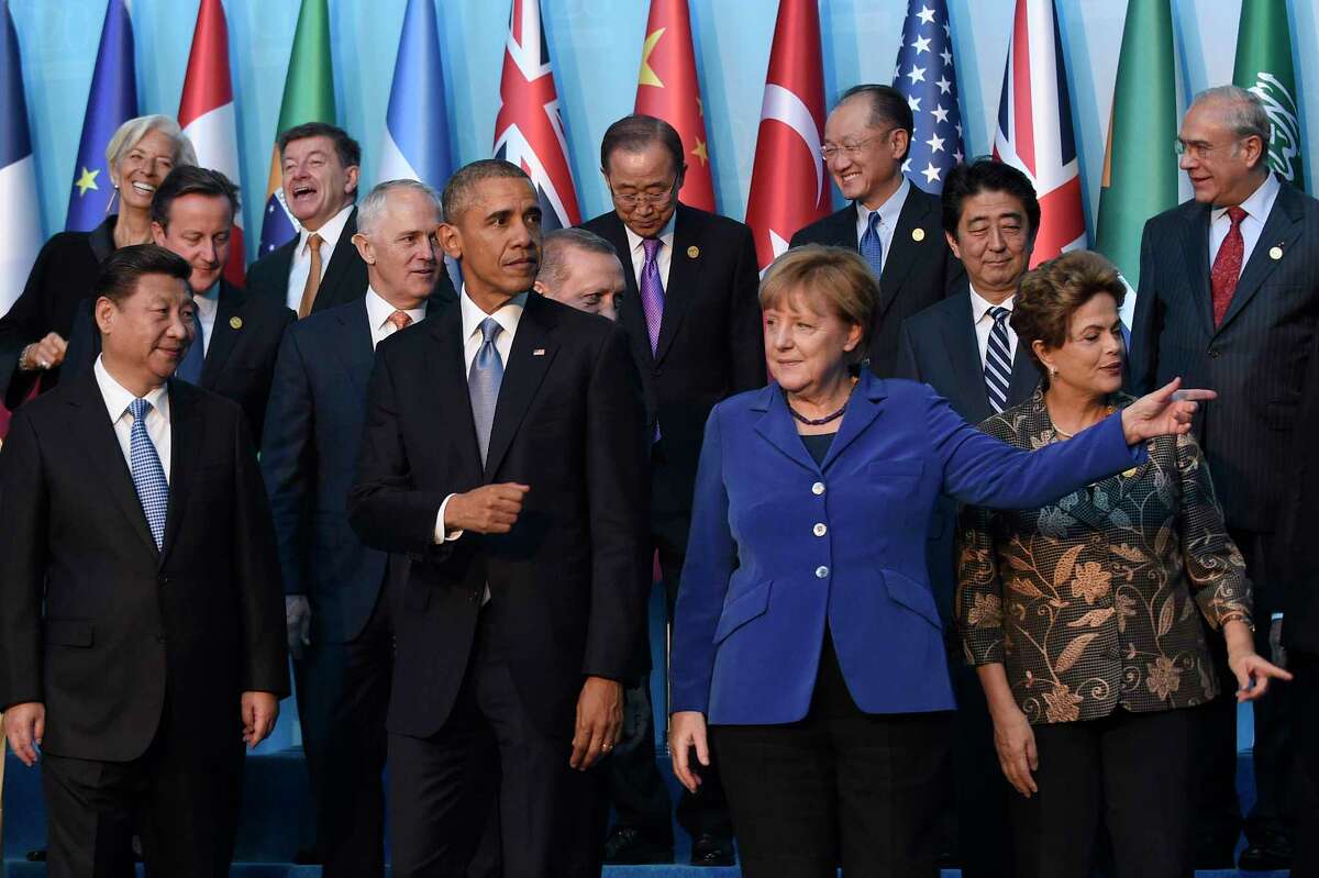 President Barack Obama, center, walks with Germany’s Chancellor Angela Merkel, in blue, and other leaders as they try to figure out which way to go following the G20 Summit group photo in Antalya, Turkey on Nov. 15, 2015.