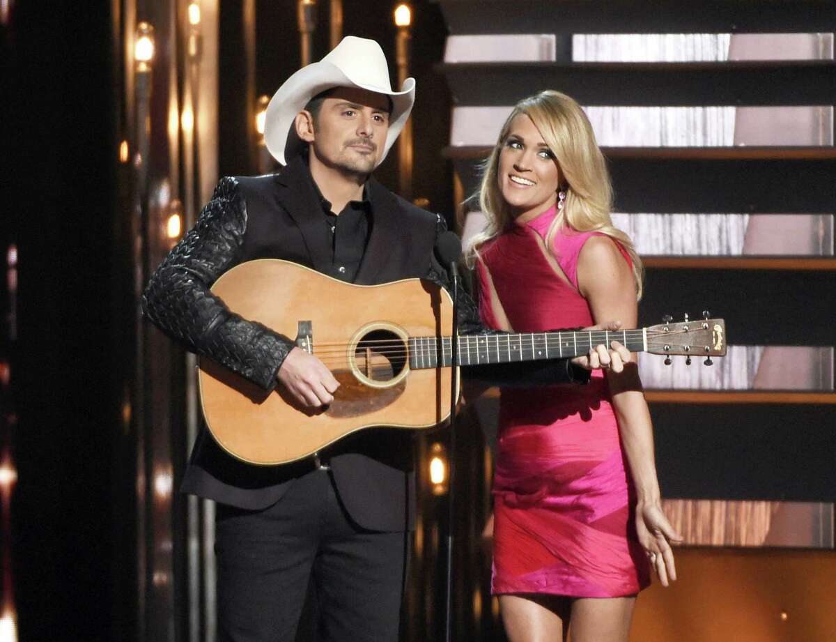 In this Nov. 4, 2015 photo, hosts Brad Paisley, left, and Carrie Underwood speak at the 49th annual CMA Awards in Nashville, Tenn. Paisley and Underwood, along with Dierks Bentley, Eric Church, Maren Morris and Keith Urban will perform at the 50th annual Country Music Association Awards show on Nov. 2.