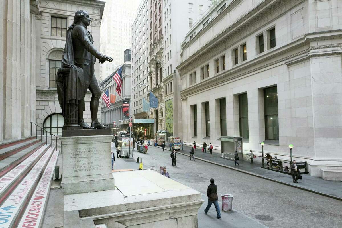 A statue of George Washington is poised above Wall Street, in New York.