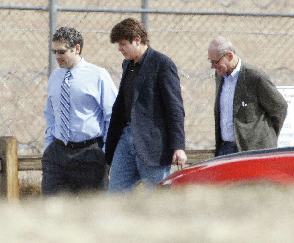 FILE - In this March 15, 2012 file photo Former Illinois Gov. Rod Blagojevich, center, walks with attorneys as he arrives at the Federal Correctional Institution Englewood in Littleton, Colo., to begin serving his 14-year sentence for corruption. The 7th U.S. Circuit Court of Appeals overturned some of the corruption convictions of the imprisoned former Governor in a ruling released Tuesday, July 21, 2015, saying prosecutors did not prove Blagojevich broke the law as he appeared to try to auction off an appointment to President Barack Obama's old Senate seat. (AP Photo/Ed Andrieski,File)
