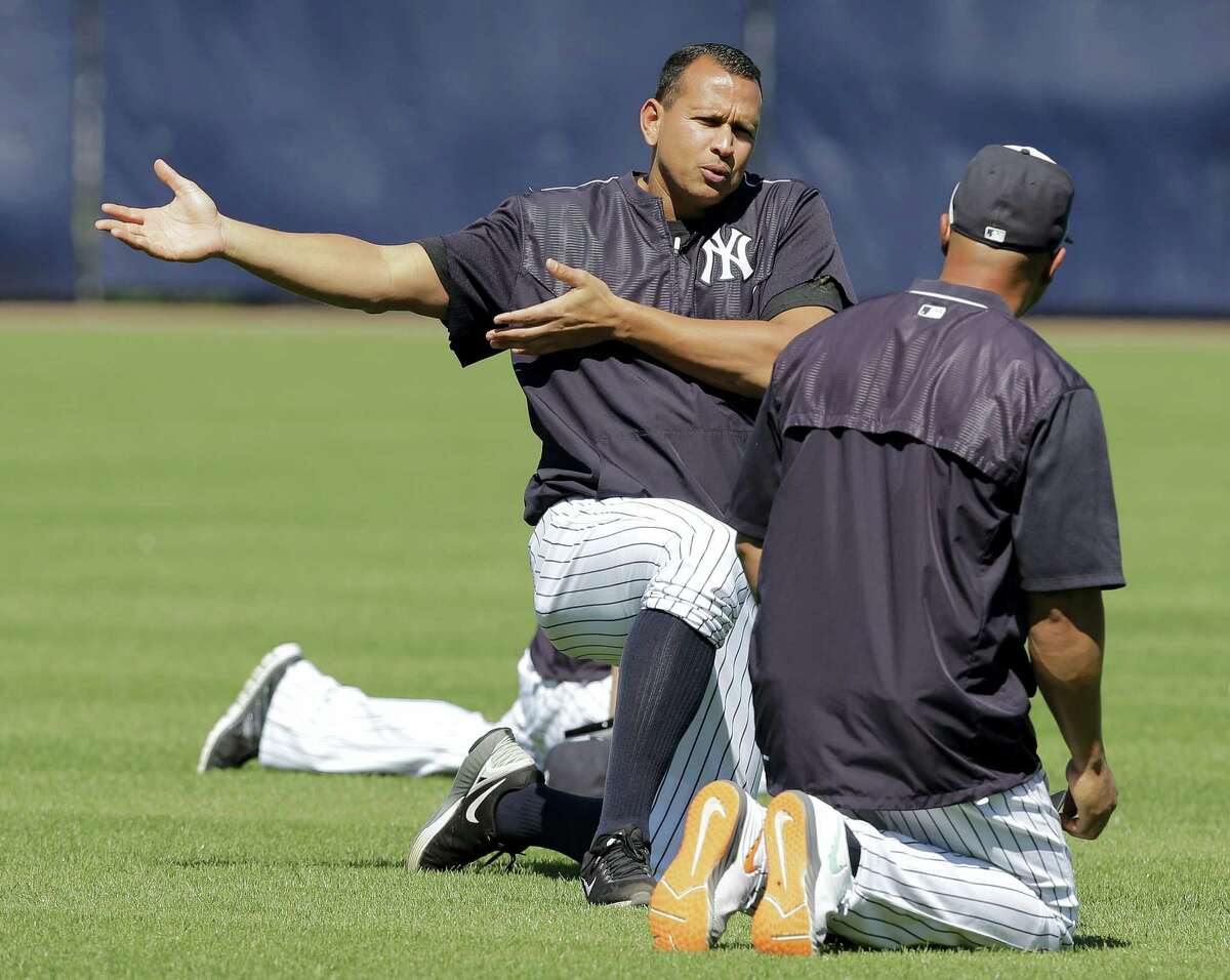 New York Yankees designated hitter Alex Rodriguez gestures as he stretches with Carlos Beltran before a spring training baseball game against the New York Mets Tuesday, March 22, 2016, in Tampa, Fla. (AP Photo/Chris O'Meara)