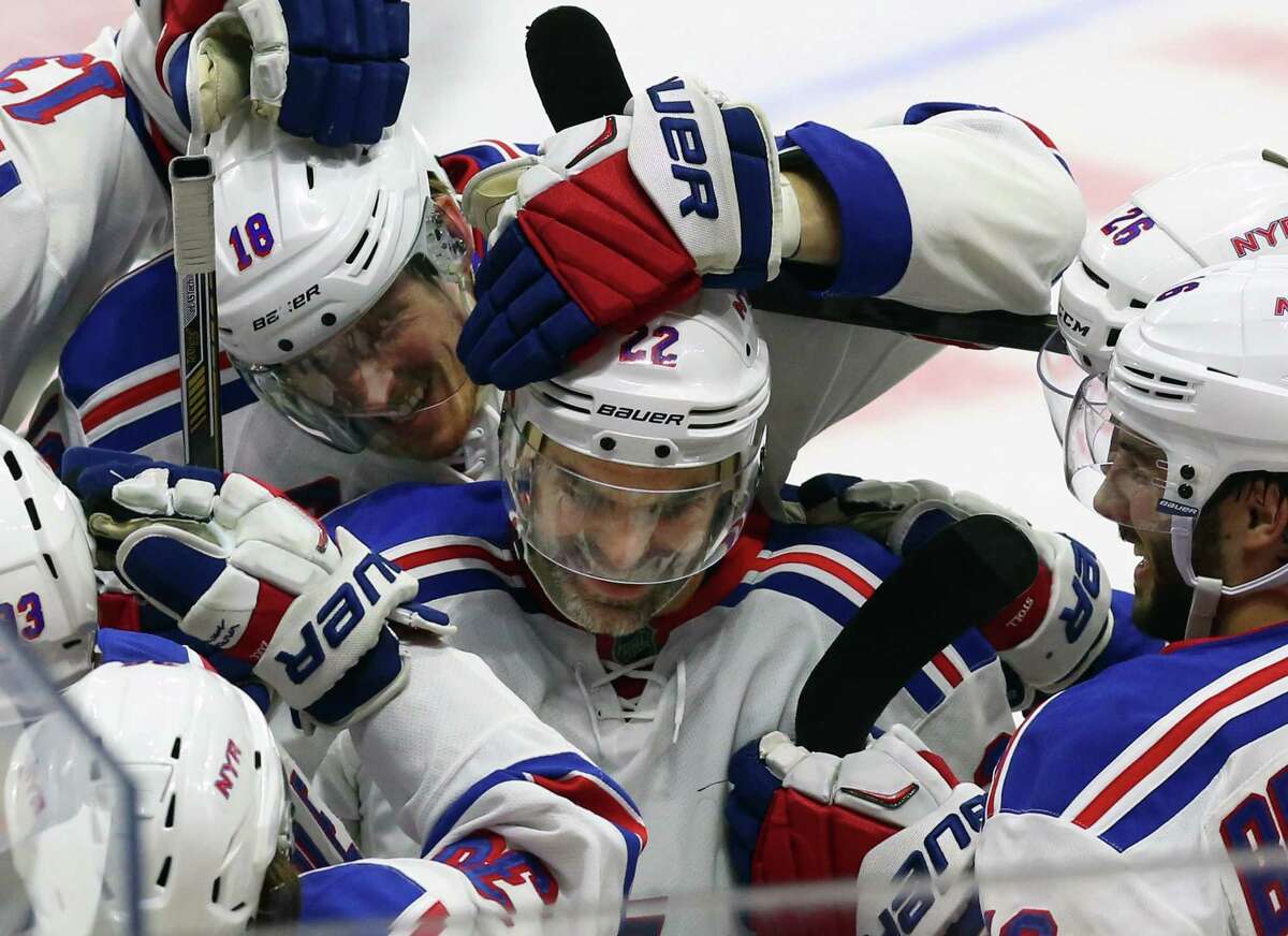 The Rangers’ Dan Boyle, center, celebrates his shootout goal with teammates after New York’s 2-1 win over the Senators on Saturday in Ottawa.