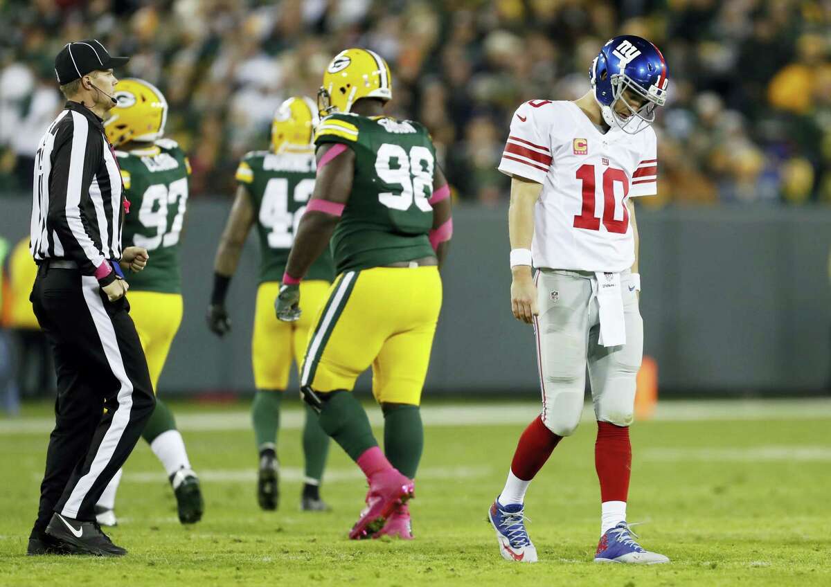 Eli Manning walks off the field after an incomplete pass during the second half on Sunday.