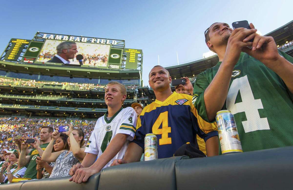 Fans watch former Green Bay Packers quarterback Brett Favre give a speech at Lambeau Field prior to his induction to the Packers Hall of Fame on Saturday.