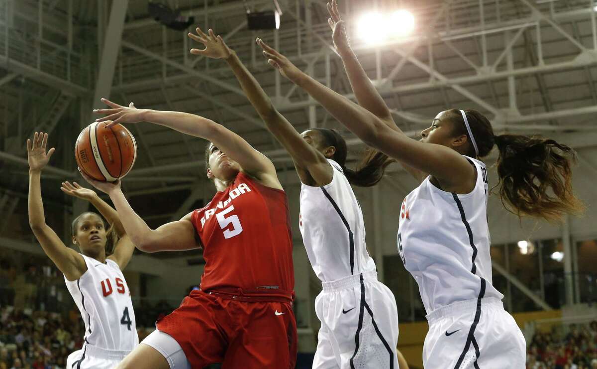Canada’s Kia Nurse, second from left, goes up for a shot against United States’ Moriah Jefferson, from left, Shatori Walker and Alaina Coates during the first quarter of the women’s basketball gold medal game at the Pan Am Games, Monday in Toronto.