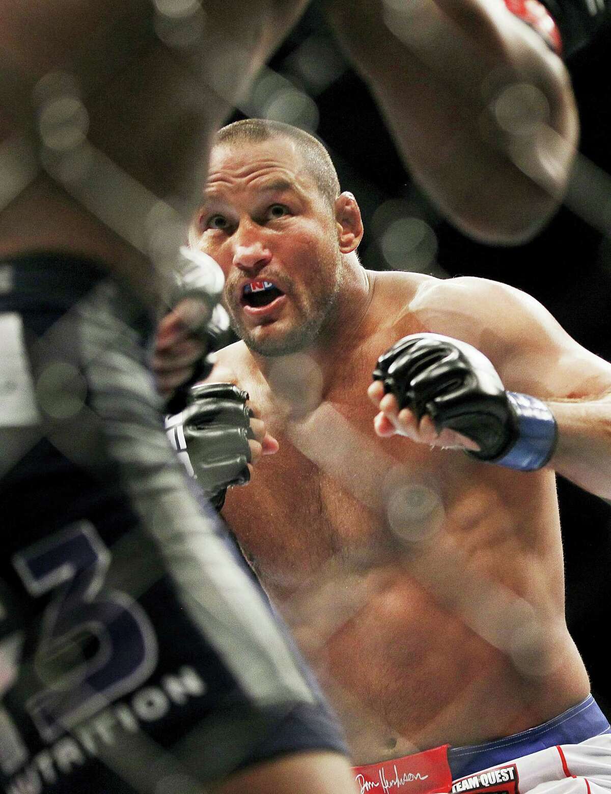 In this June 15, 2013 photo, Dan Henderson moves in on Rashad Evans during a UFC 161 mixed martial arts bout in Winnipeg, Manitoba. Henderson failed to cap his 19-year career by beating middleweight champion Michael Bisping in the main event of UFC 204 on Oct. 9, 2016 in Manchester, England.