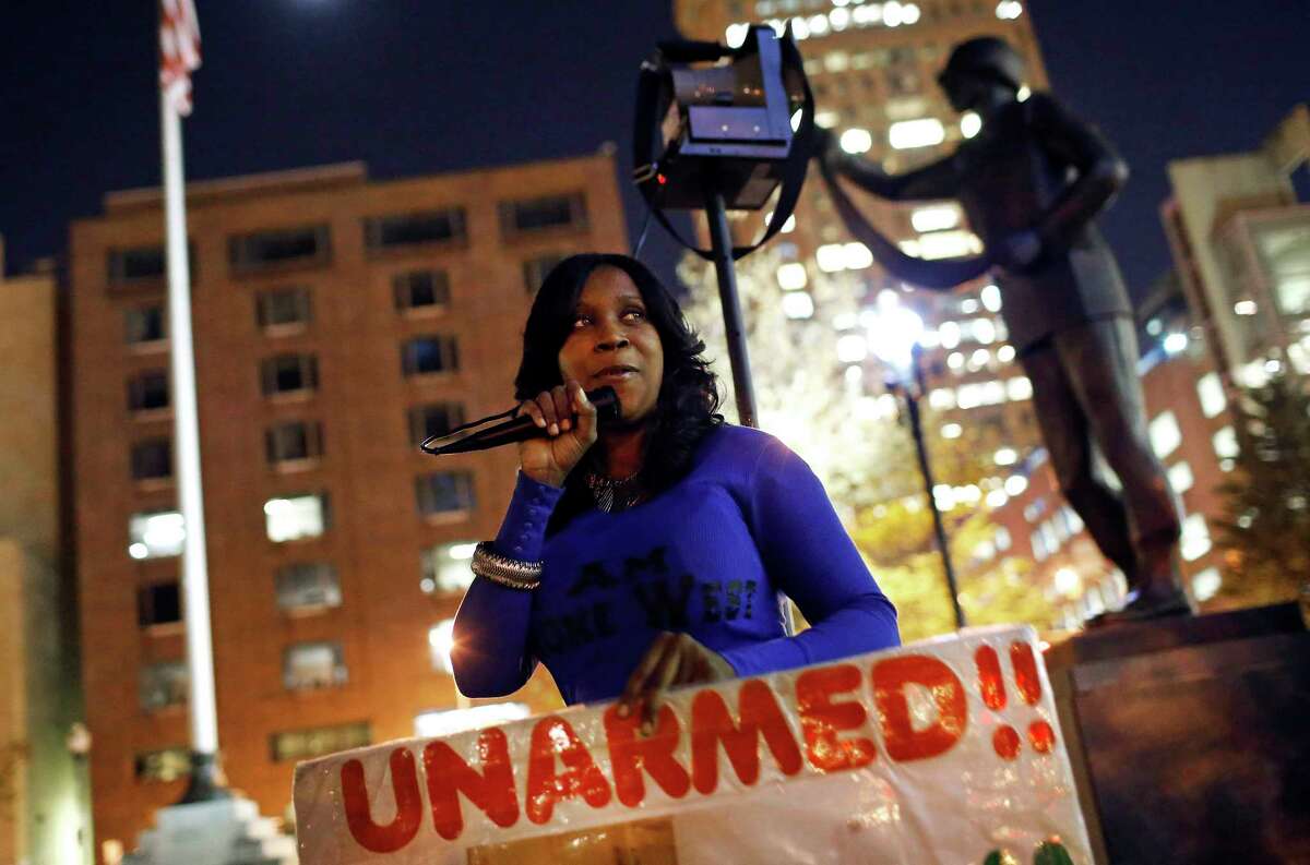 In this Oct. 21, 2015 picture, Tawanda Jones leads a vigil for her brother, Tyrone West, outside of Baltimore City Hall. West died under murky circumstances in July 2013 after an encounter with Baltimore police. Every Wednesday since then, Jones has stood vigil -- in front of City Hall, outside the state’s attorney’s office, on an East Baltimore street corner, in the freezing dark of winter, in the stifling heat of summer. Sometimes she is backed by supporters; sometimes she stands alone, a grim reminder of a deep divide between the police and the people of Baltimore.