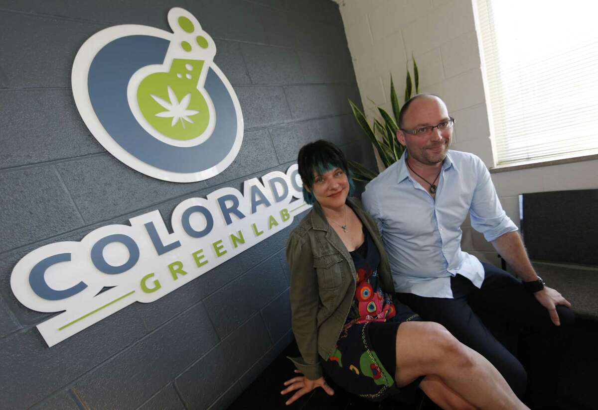 In this Wednesday, June 17, 2015 photo, Frank Conrad, right, head of a pot-testing lab Colorado Green Lab, and Cindy Blair pose for photos at their lab in Denver. In states that regulate marijuana, officials are just starting to draft rules governing safe levels of chemicals.