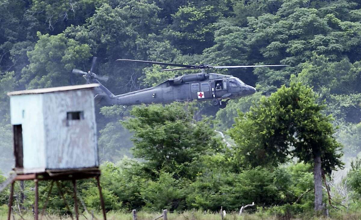 A military Helicopter joins in the search efforts Friday, June 3, 2016, for 6 missing soldiers from Fort Hood, Texas.