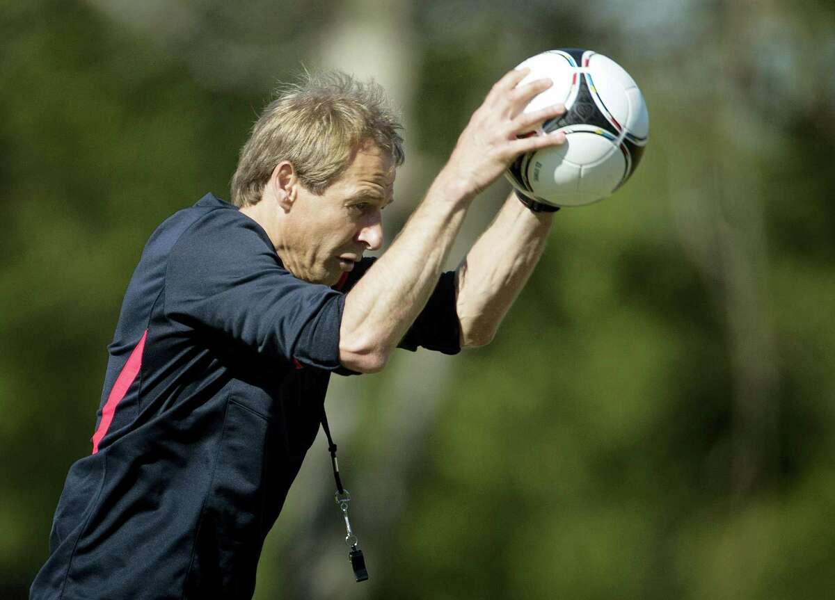 US coach Jurgen Klinsmann slams the ball to the ground during a practice at the FIU Soccer Stadium in Miami.