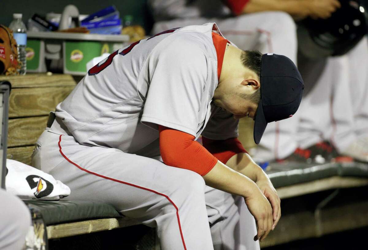 Junichi Tazawa sits in the dugout after being removed during the eighth inning on Thursday.