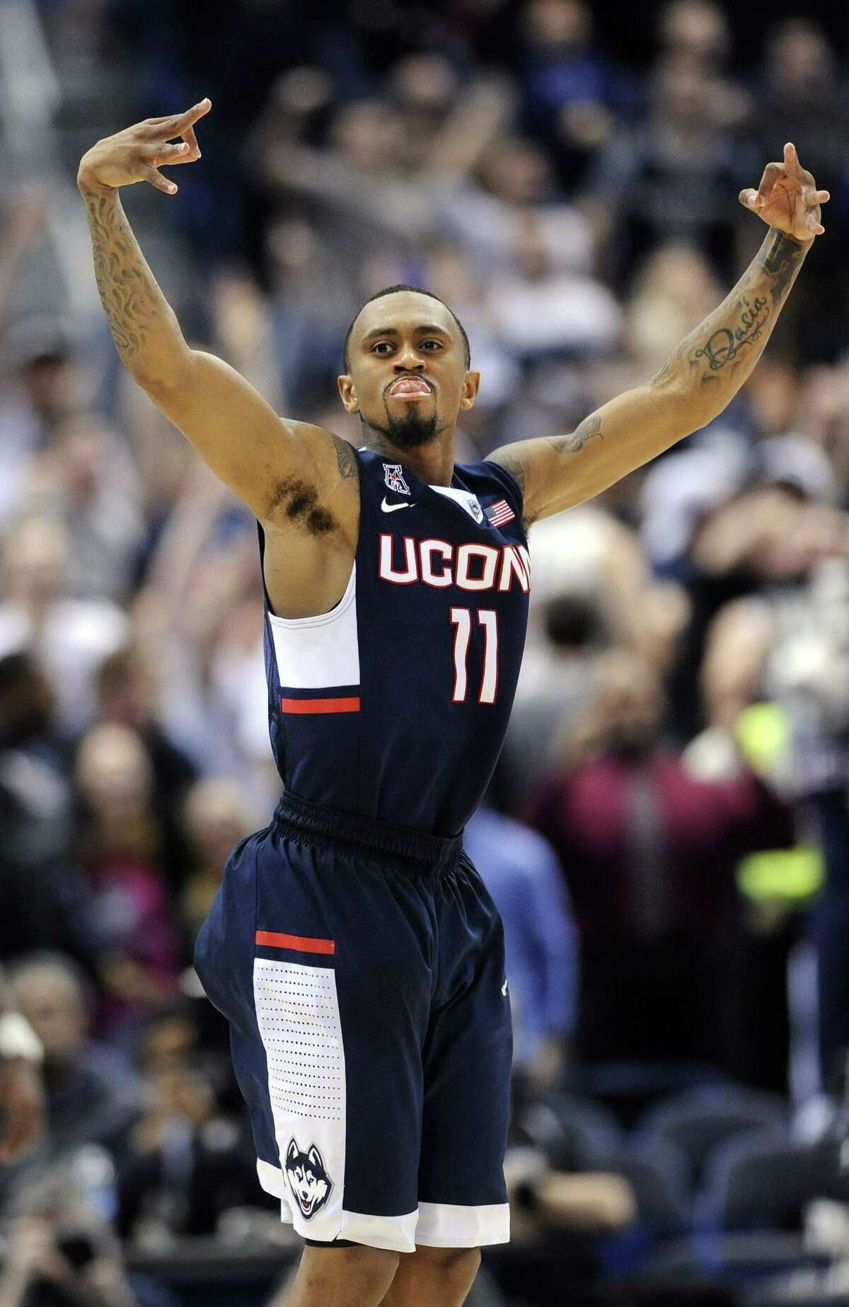 UConn’s Ryan Boatright celebrates after hitting a 3-pointer to tie the game during the second half of the American Athletic Conference semifinals on Saturday in Hartford. The Huskies won 47-42.