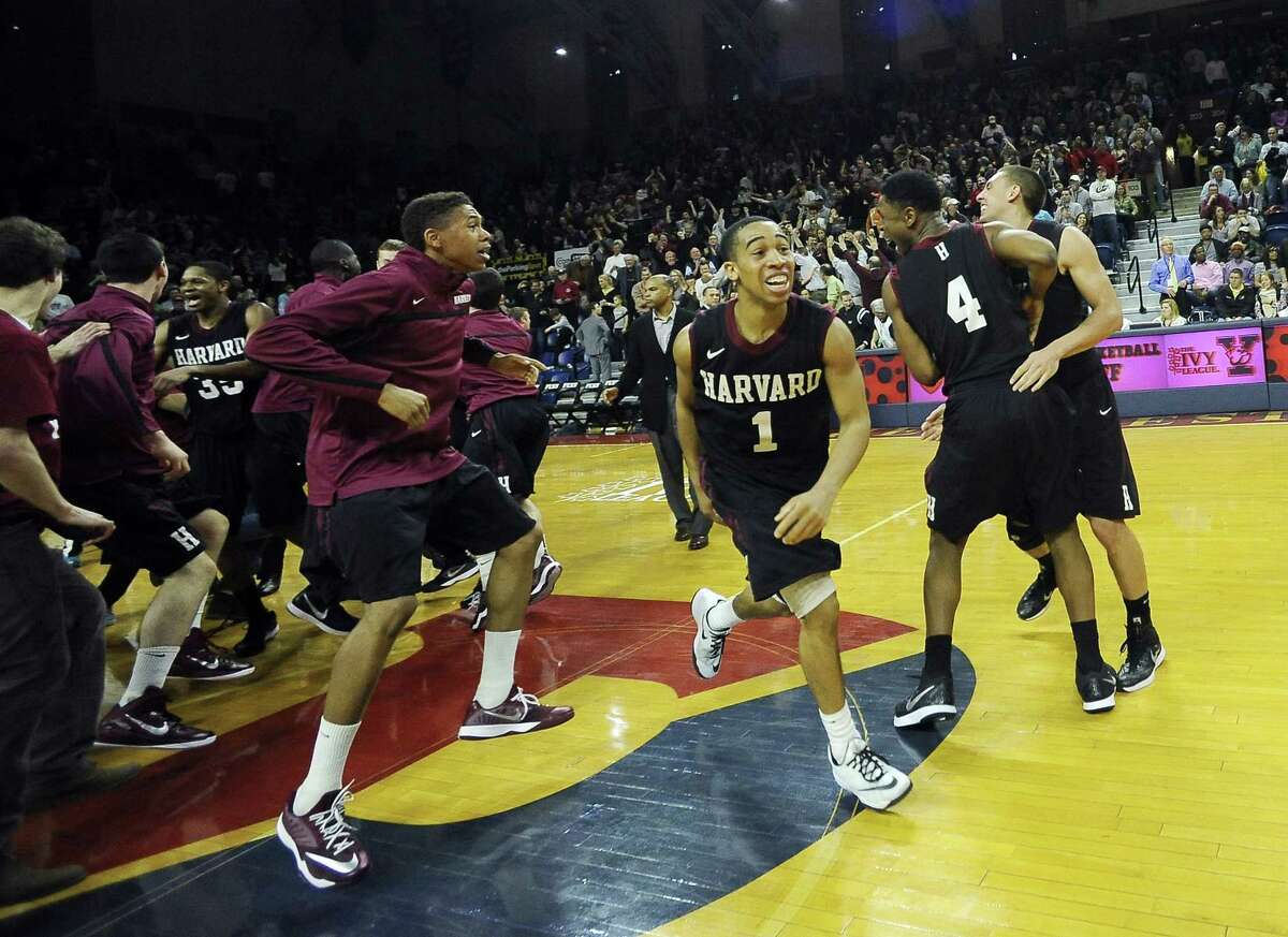 Harvard’s Siyani Chambers (1) celebrates with his team after the Crimson beat Yale 53-51 in the Ivy League playoff on Saturday at The Palestra in Philadelphia.
