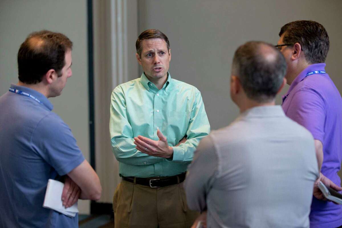 New York Mets assistant general manager John Ricco, second from left, speaks to reporters after attending the general managers’ meetings Wednesday in Boca Raton, Fla.