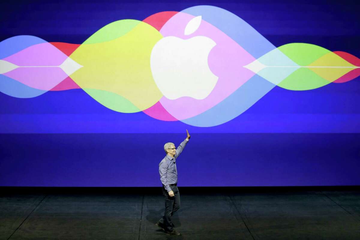 In this Sept. 9, 2015 photo, Apple CEO Tim Cook waves during the Apple event at the Bill Graham Civic Auditorium in San Francisco. Apple is expected to unveil some new additions to its current family of iPhone and iPad devices at the company’s product announcement on Monday, March 21, 2016.